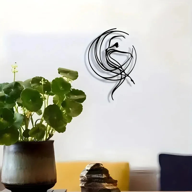 Metal wall art featuring a dancer silhouette displayed above plants in a living room