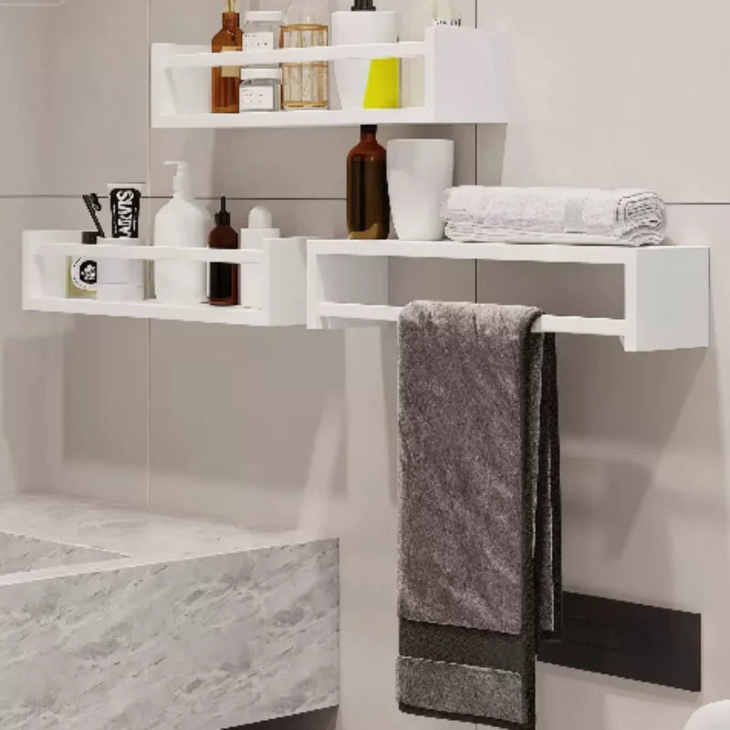 White floating shelves mounted in a bathroom, organizing toiletries, bottles, and folded towels.