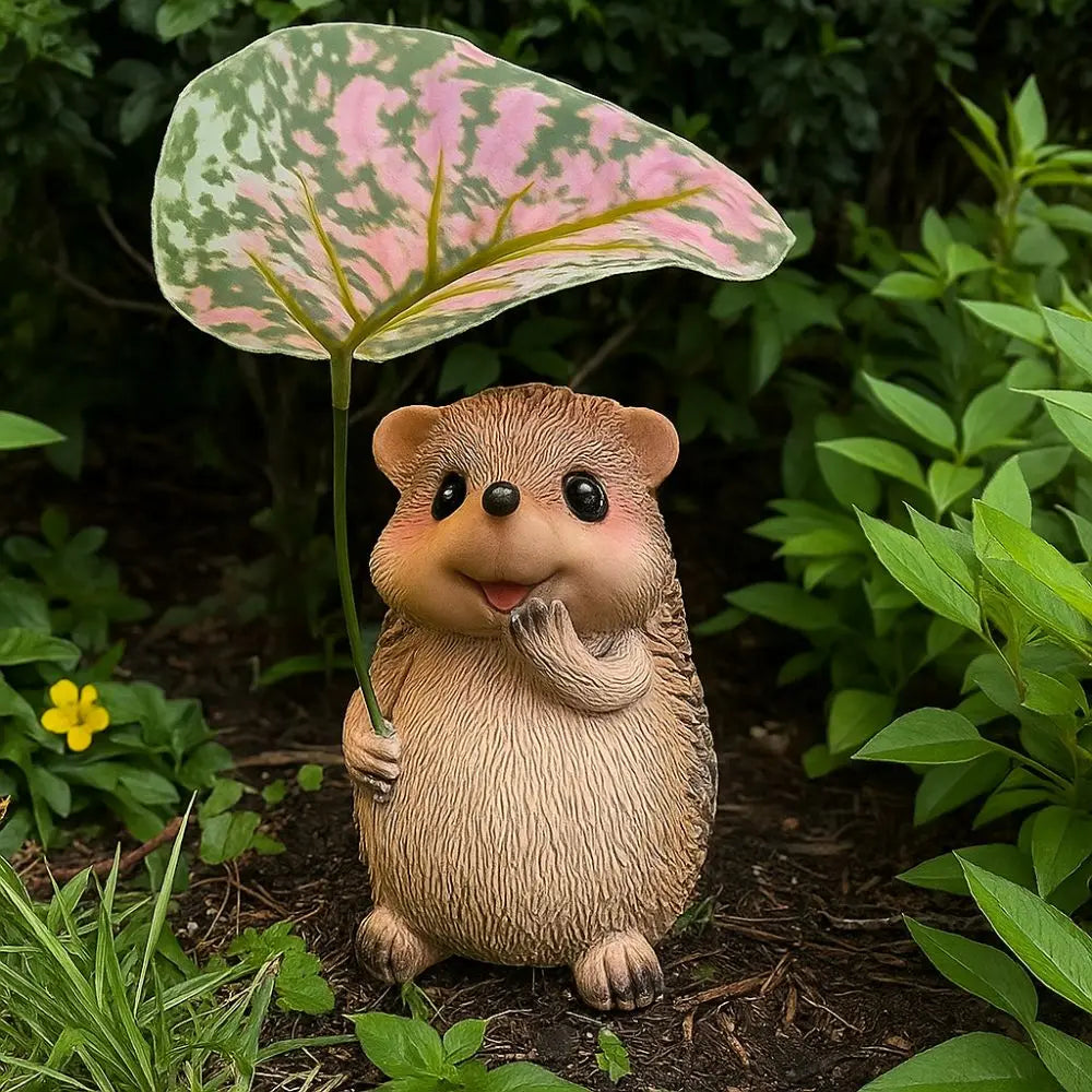 resin hedgehog statue holding a leafy umbrella in a garden bed