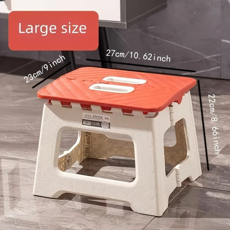 folding step stool with red non-slip top and visible size measurements in inches and centimeters