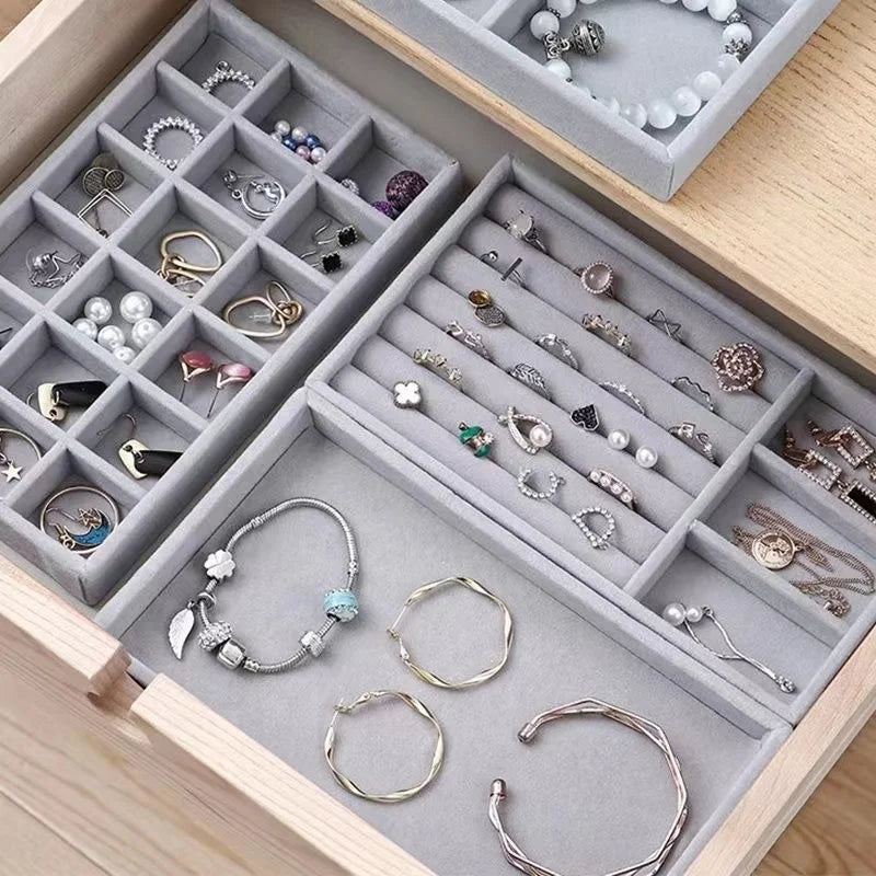 Drawer with multiple velvet jewelry trays organizing rings, earrings, and bracelets