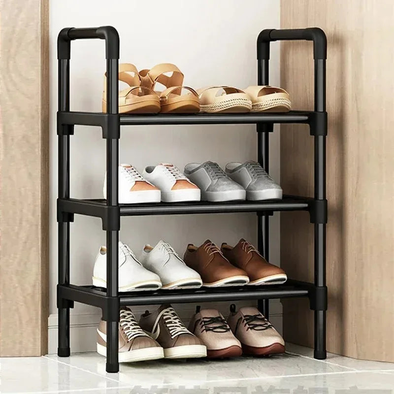 three-tier black shoe rack with assorted shoes in a small entryway