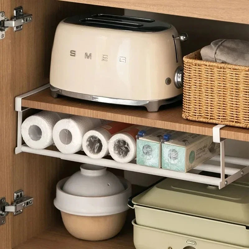 white under-shelf storage rack used for kitchen rolls and pantry items in a cabinet