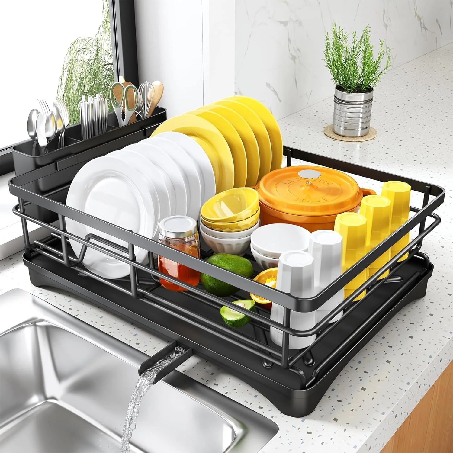 large black steel dish drying rack with drainboard and utensils holder on a kitchen counter by a sink