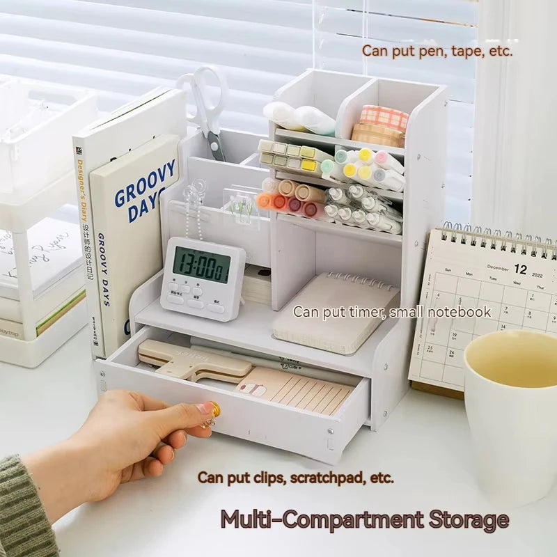 hand opening drawer of white desk organizer filled with stationery, books, and supplies in a light-filled room