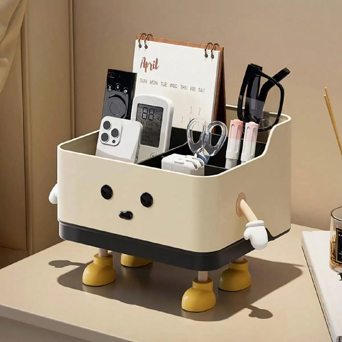 Beige character-inspired desktop organizer holding pens, scissors, remotes, and glasses