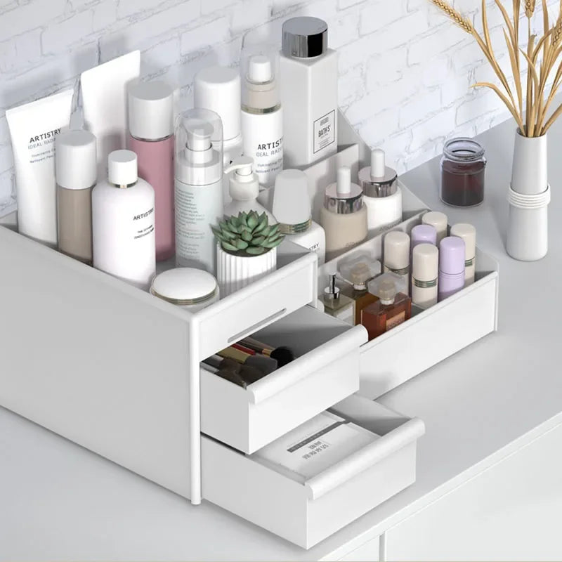 White drawer-style plastic desktop organizer filled with skincare bottles, makeup, and small accessories on a vanity