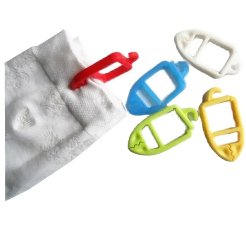 Colorful plastic sock clips being attached to a white sock, showing red, blue, green, white, and yellow clips.
