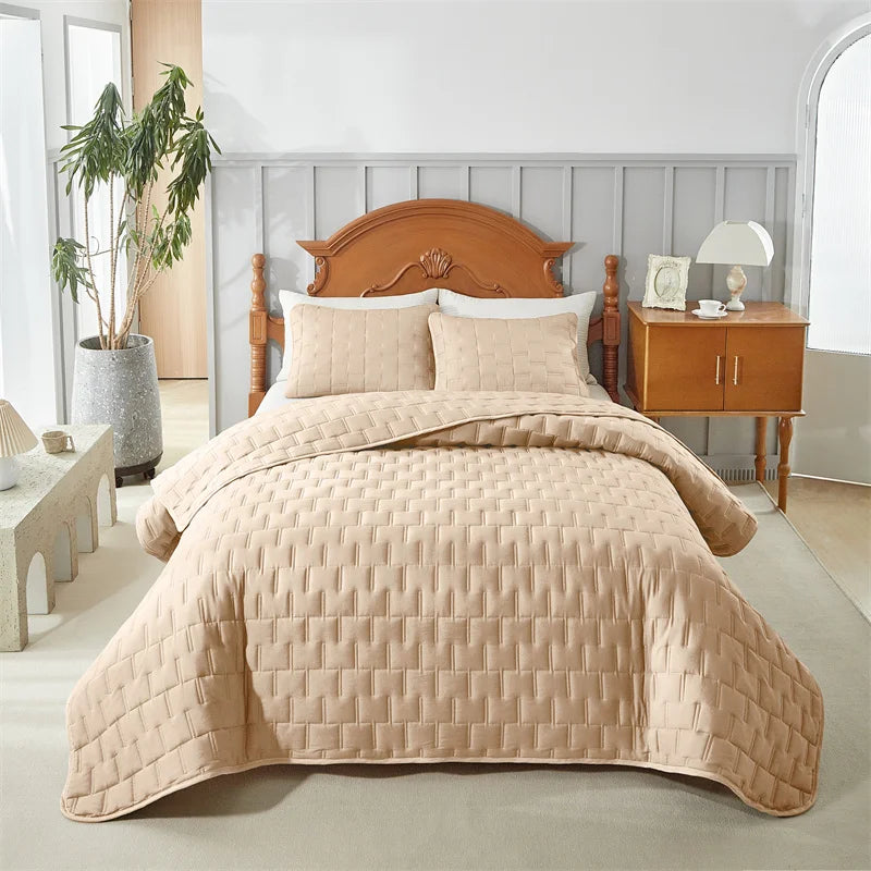 Beige lightweight bedding set covering a bed in a softly lit bedroom