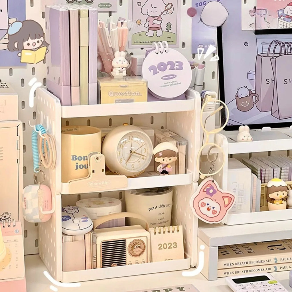 Pegboard desktop organizer with three tiers, stationery, and pastel decor on a home desk