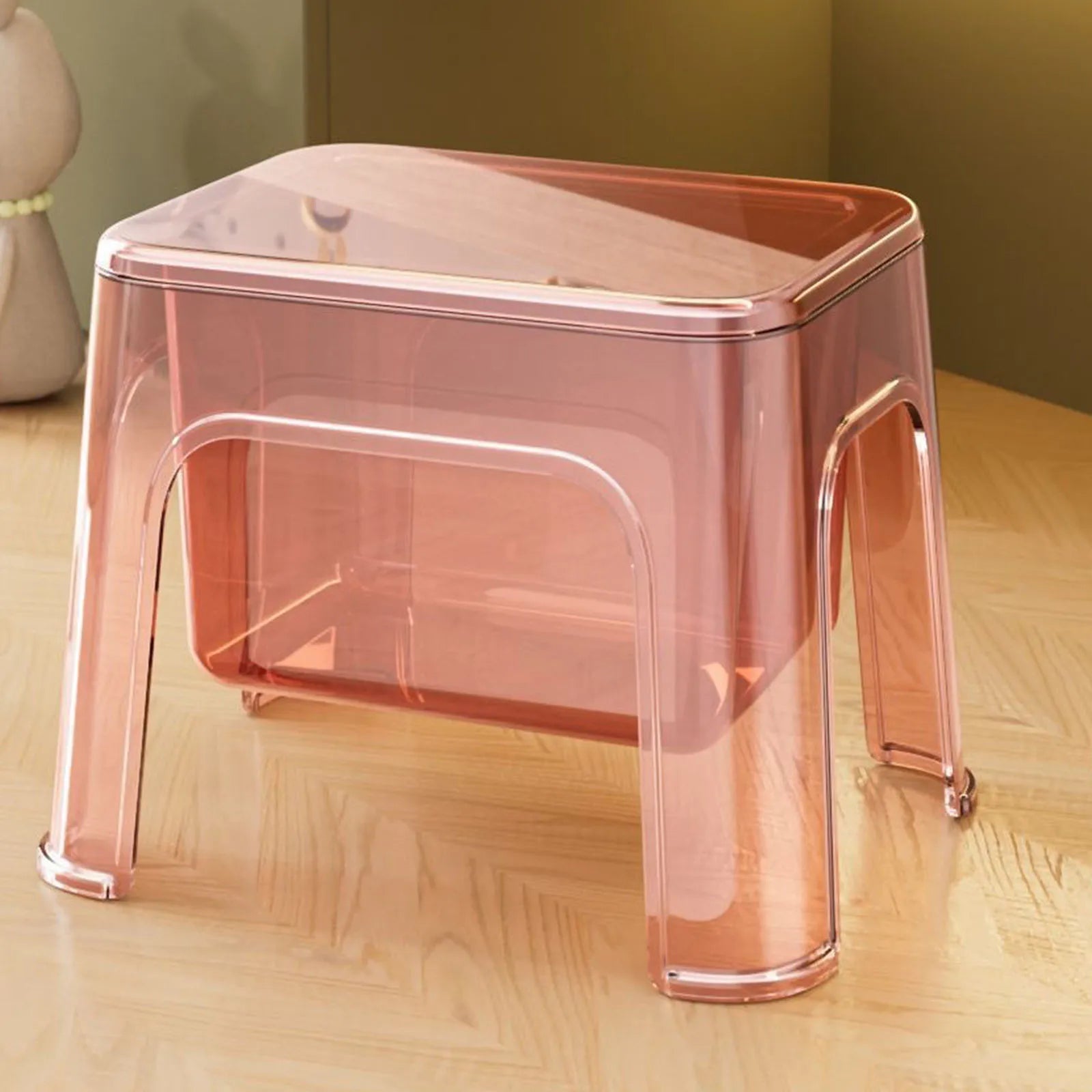 Pink transparent step stool in a home setting on wood floor