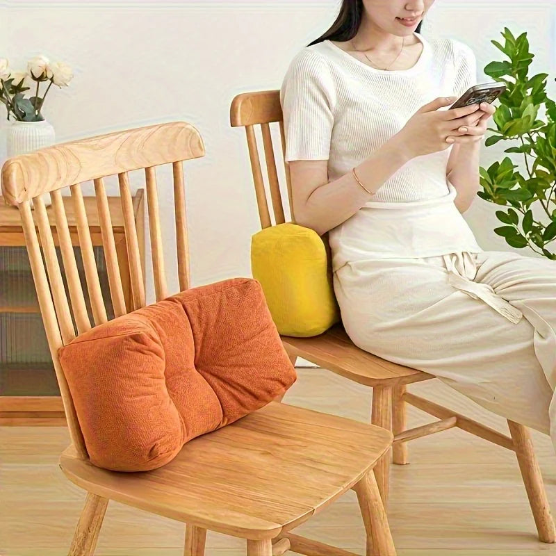Two wooden chairs with lumbar support cushions in use, one yellow and one orange, in a bright home setting