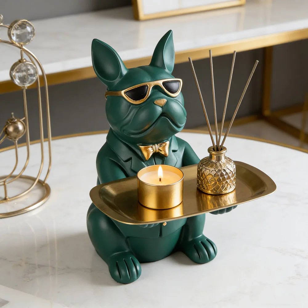 Green bulldog catchall tray with a candle and small diffuser on a marble coffee table