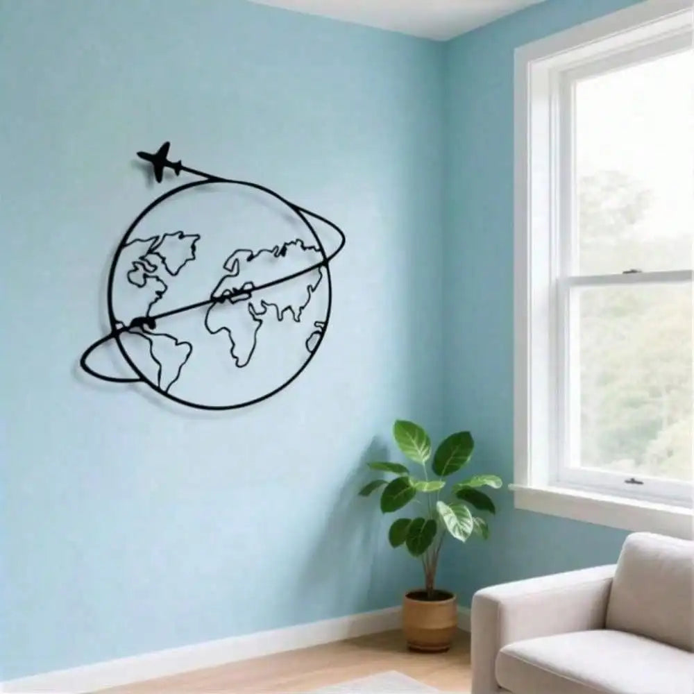 Minimalist metal world map wall art with airplane detail on blue living room wall