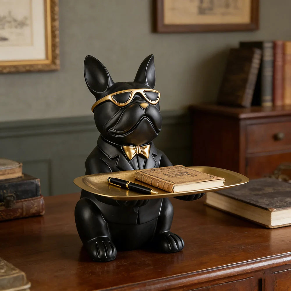 sculptural bulldog catchall tray with notebook and pen on an office desk