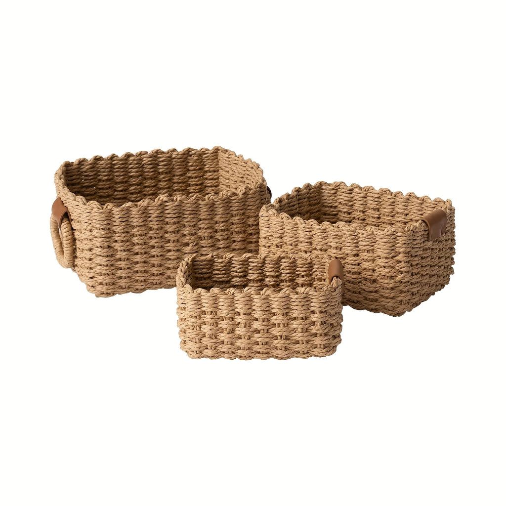 Set of three empty handwoven paper rope storage baskets in small, medium, and large sizes