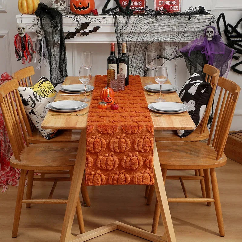 dining room setup with Halloween decorations and pumpkin emboss table runner