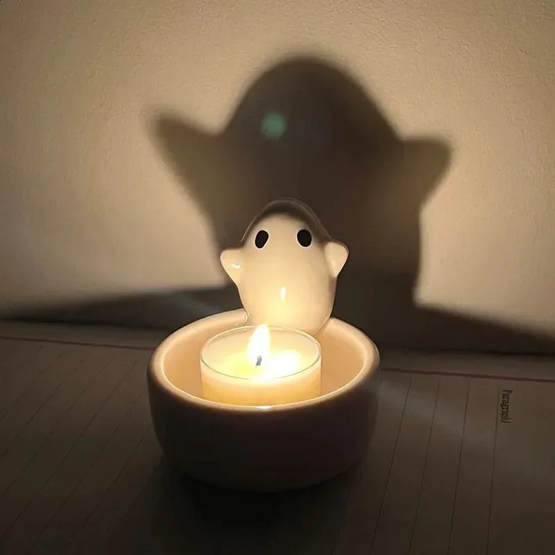 ghost ceramic candle holder casting a shadow on a wall
