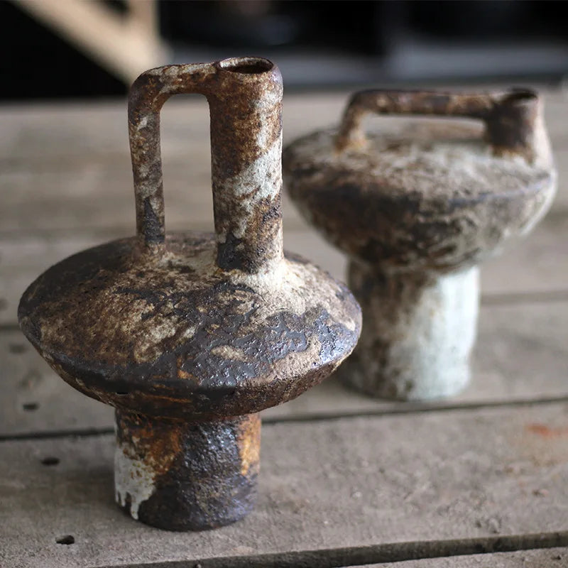 Close-up of rustic ceramic vases showing earthy textured finish on tabletop