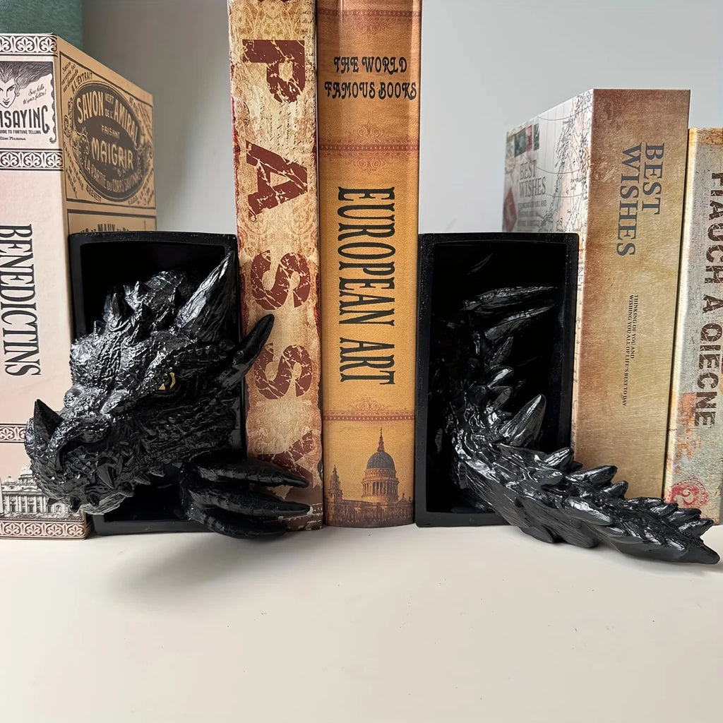 Black dragon head and tail resin bookends holding books on a shelf