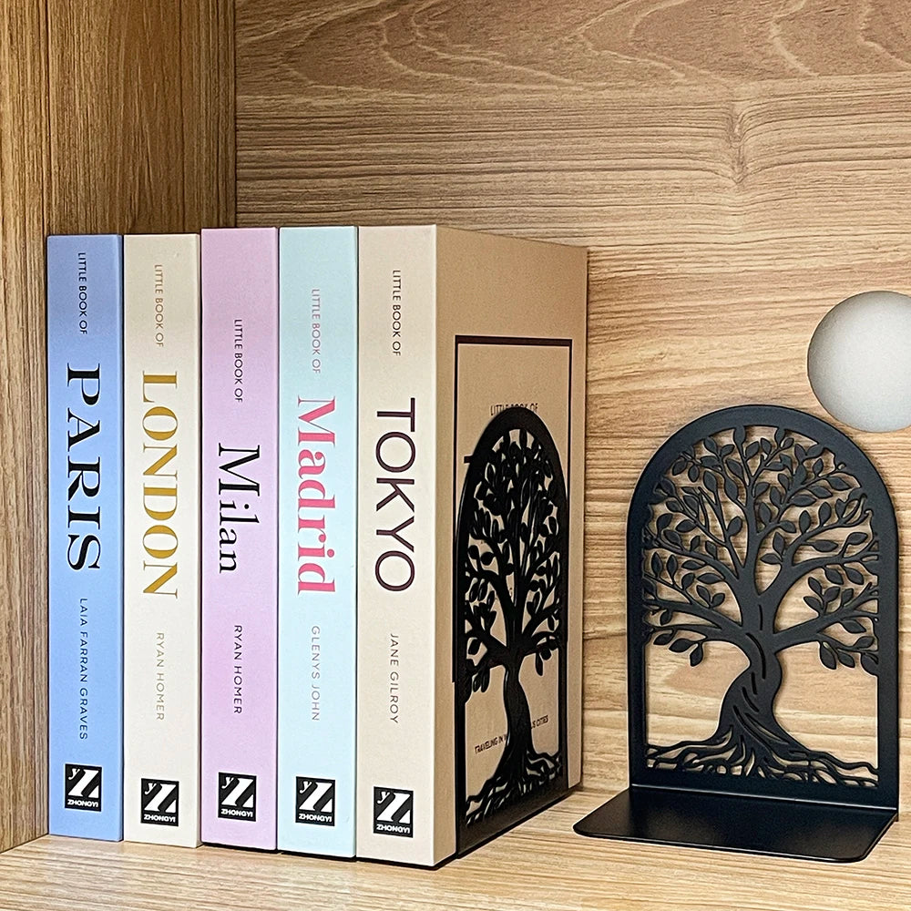 Decorative black metal Tree of Life bookend supporting travel books in a home library