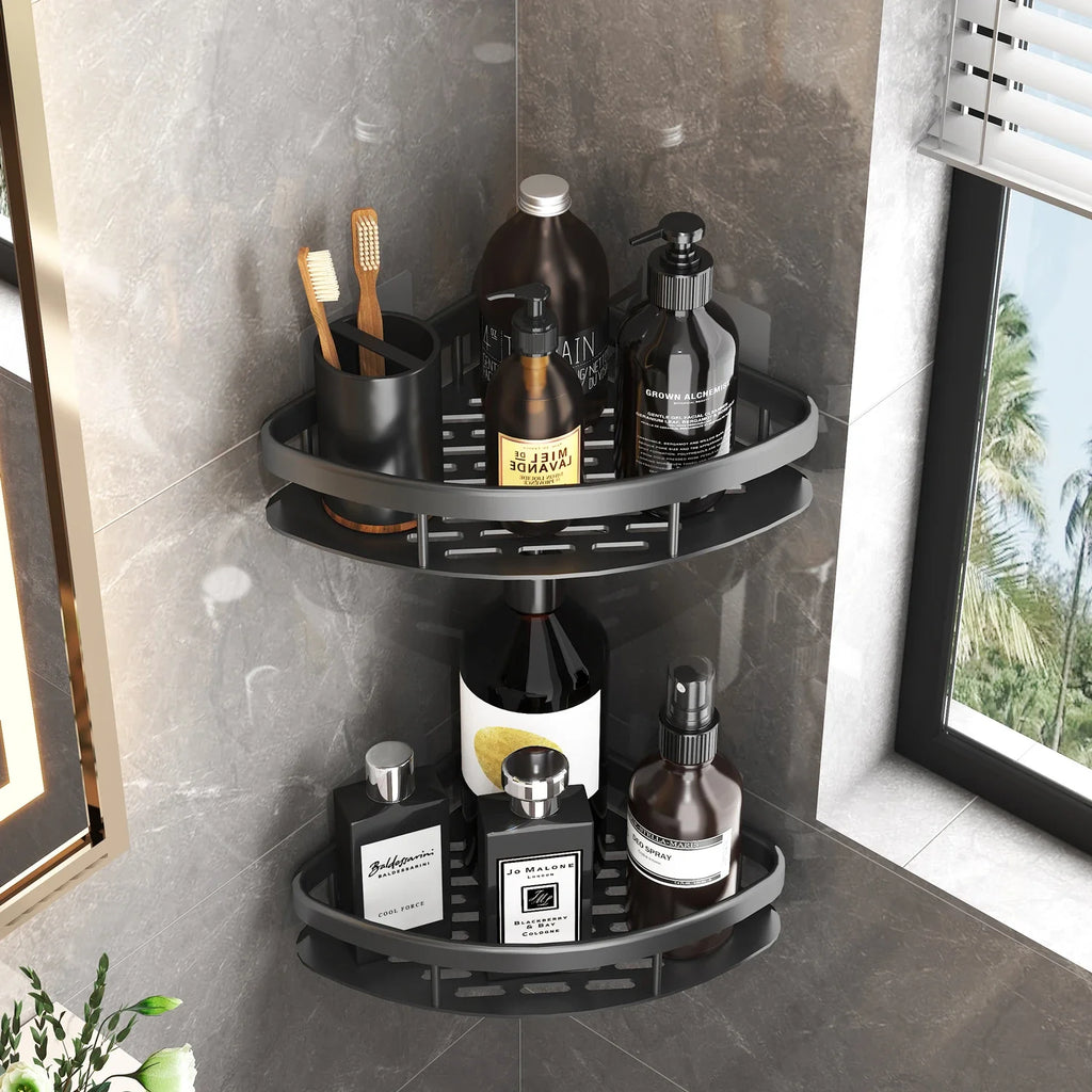 Black metal corner shower shelf with two tiers holding bath bottles, on a tiled bathroom wall