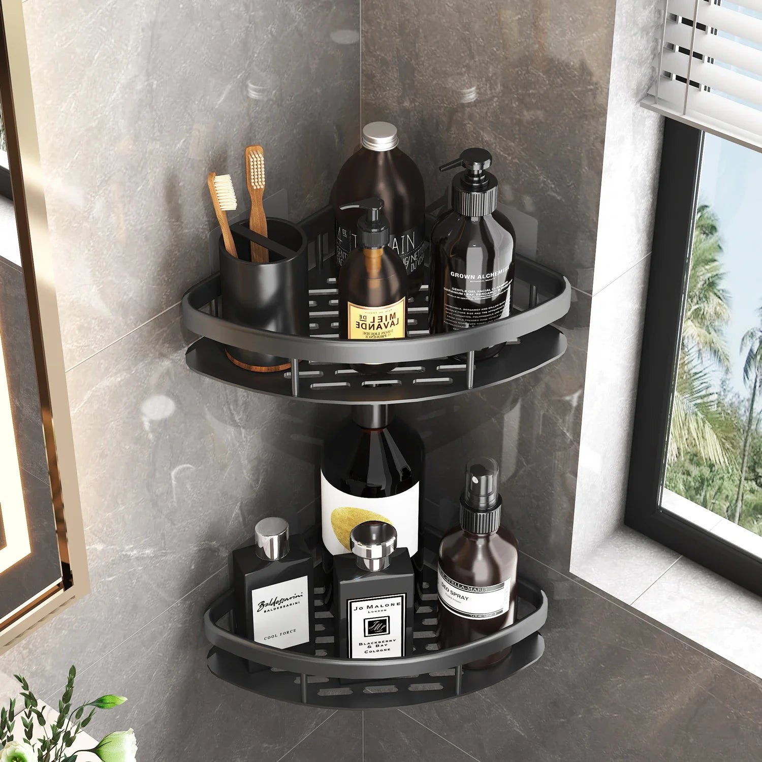 Black metal corner shower shelf with two tiers holding bath bottles, on a tiled bathroom wall