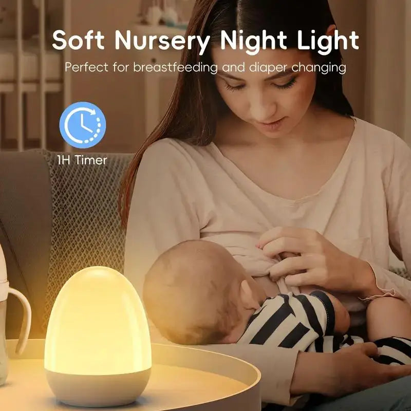 Egg night light on a nursery table while a mother breastfeeds an infant