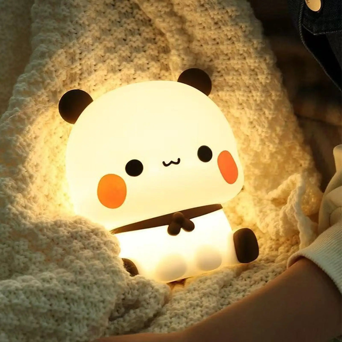 Bear-shaped LED night light nestled in a cozy blanket, creating a calming glow