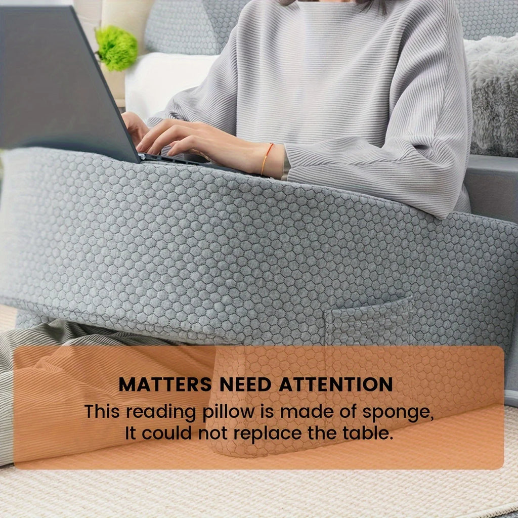 Close-up of grey reading pillow with warning note that it is made of sponge and does not replace a table