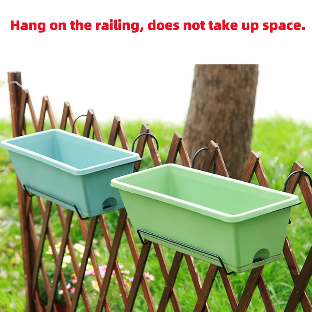 Light green and blue rectangular railing planters hanging on a wooden balcony fence outdoors, text displayed above