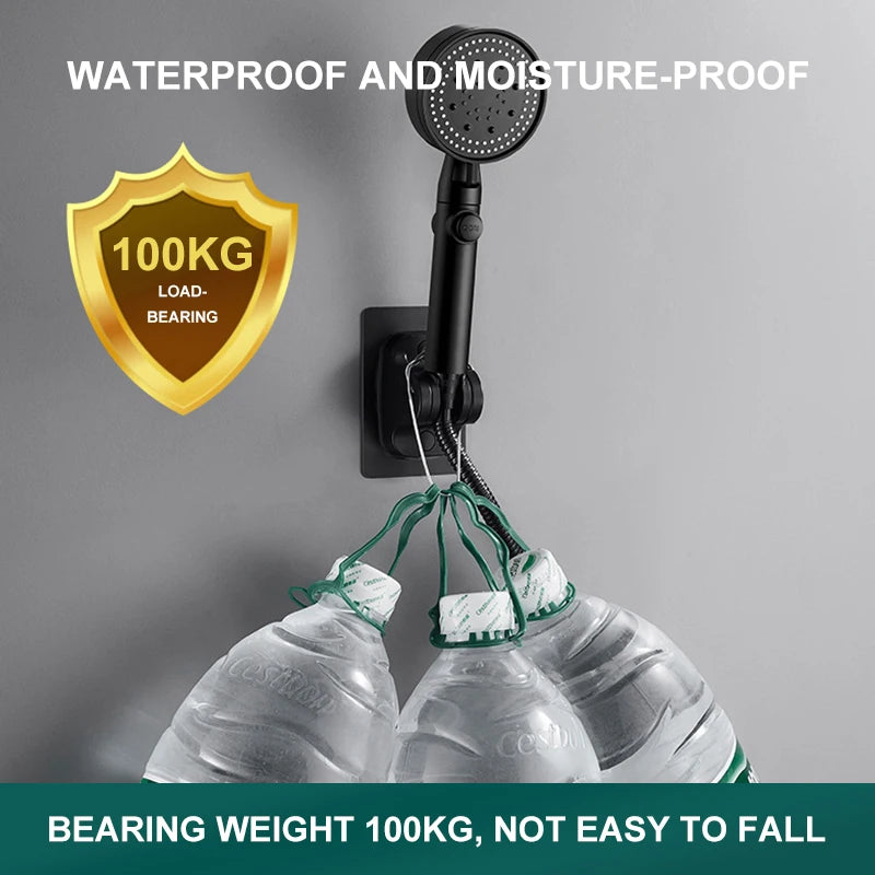 Black self-adhesive shower head holder supporting handheld shower and water bottles on smooth bathroom wall