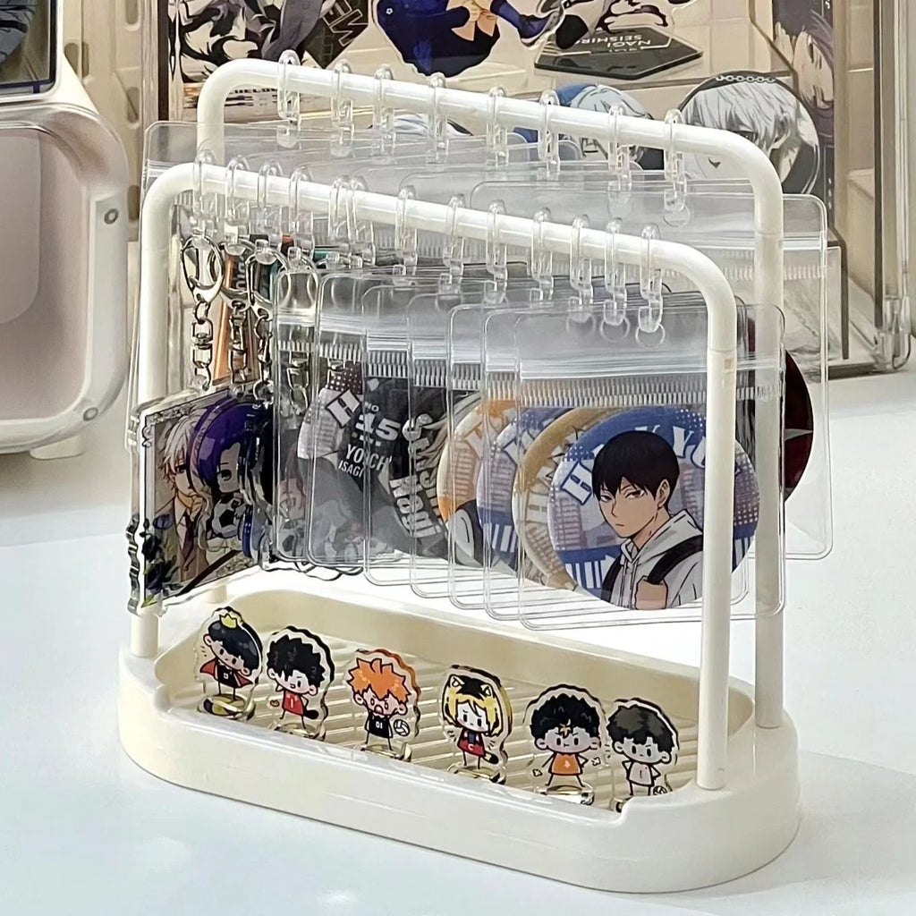 Desktop badge and keychain organizer on a white desk holding pins and accessories