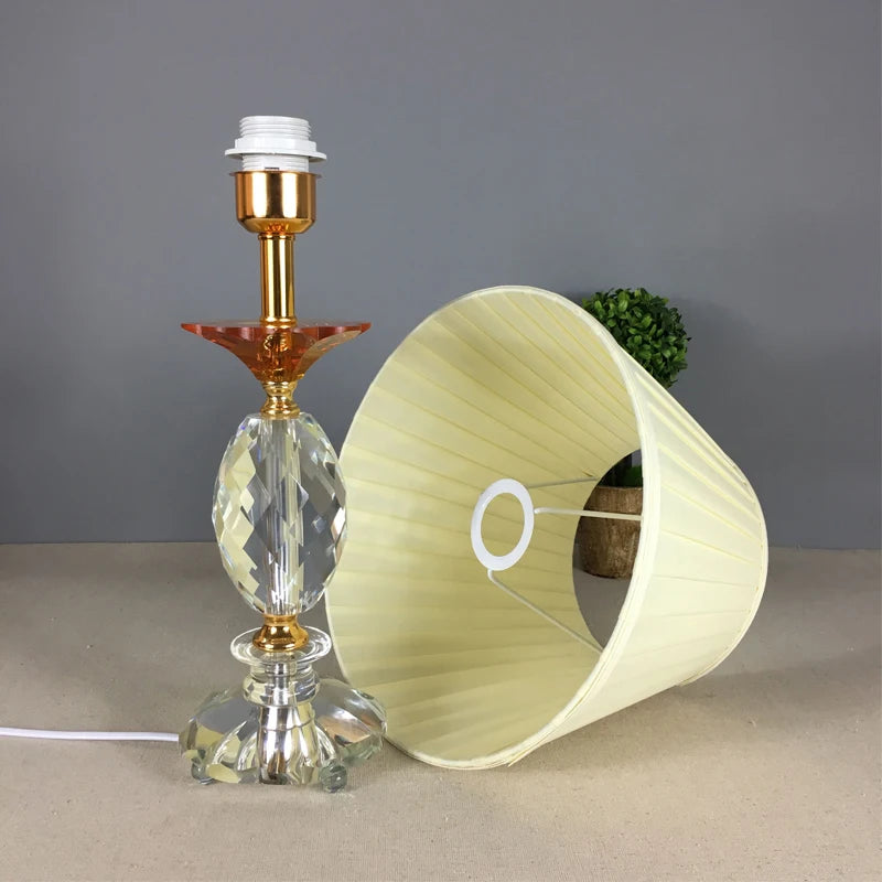 Pleated cloth lampshade removed from a crystal table lamp base