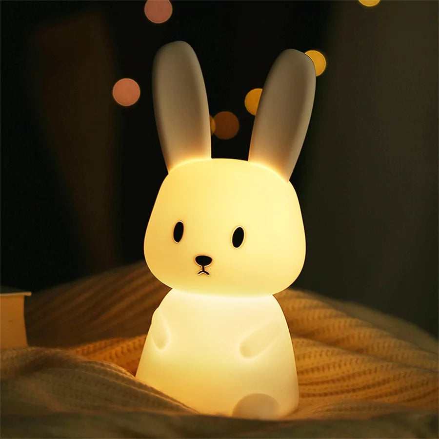 bunny silicone LED night light glowing softly on a blanket