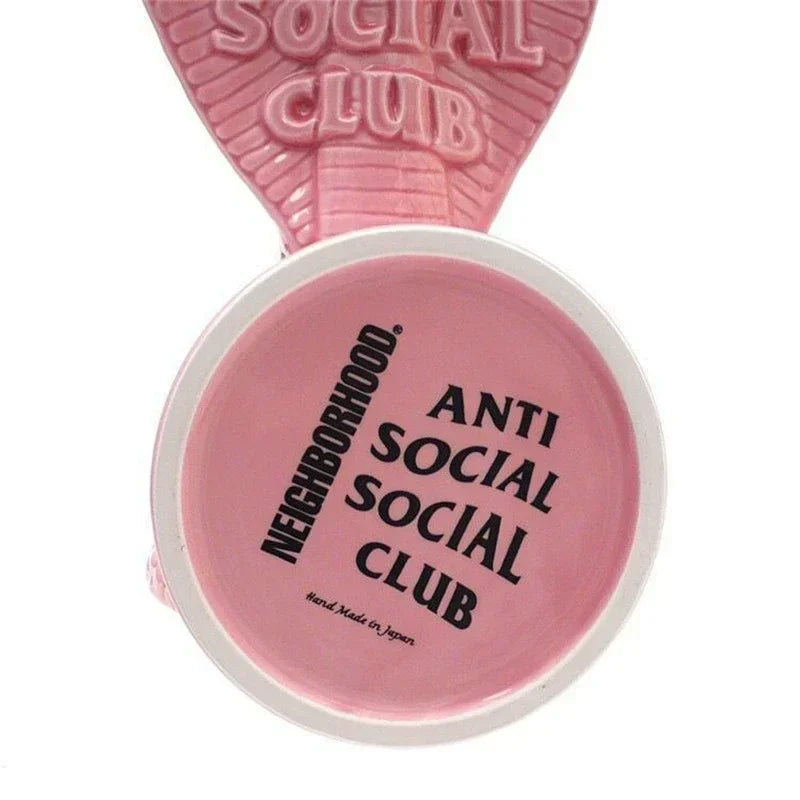Underside of pink cobra ceramic holder showing printed text details