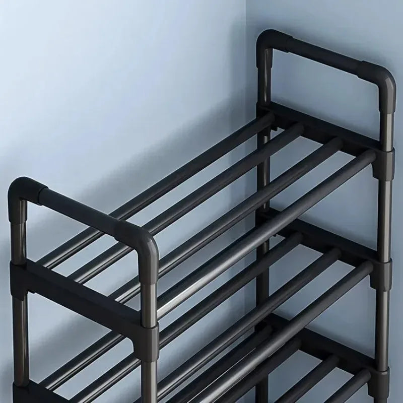 close-up of black multi-tier shoe rack corner detail against blue wall