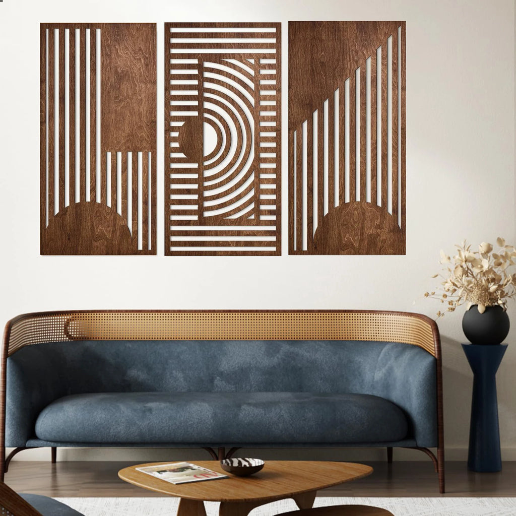 Three-piece abstract wooden wall art panels above a rattan sofa in a modern living room
