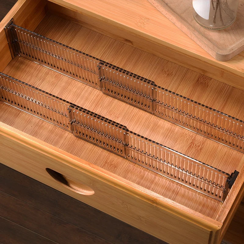 Pair of clear adjustable plastic dividers neatly organizing a wooden drawer