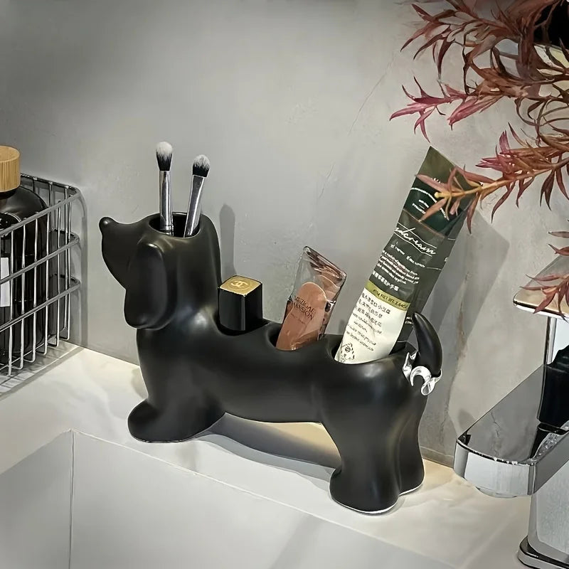 Black dachshund bathroom holder with toothbrushes, makeup brushes, and toothpaste inside on a sink counter
