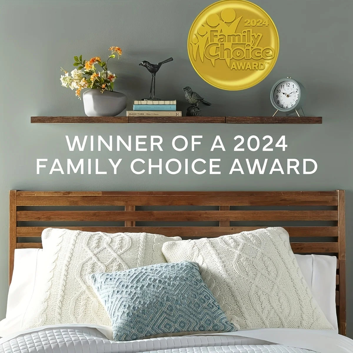 Long floating wood shelf styled above a bed with decor and pillows