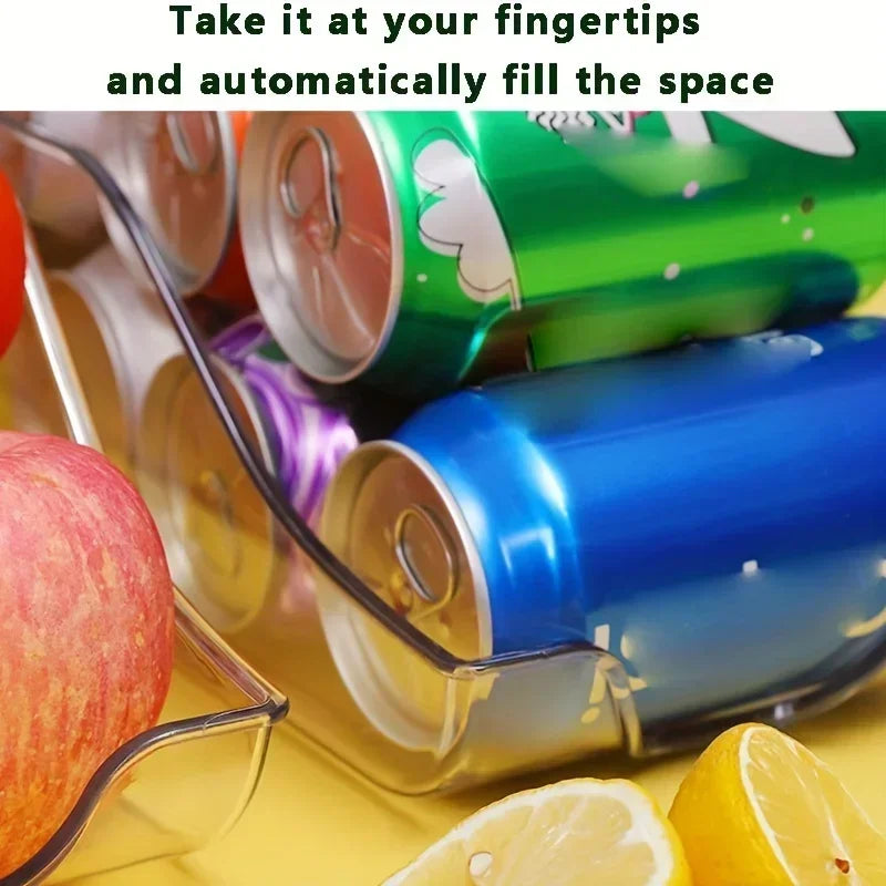 Close-up of clear can dispenser with green and blue soda cans, apples, and lemon slices