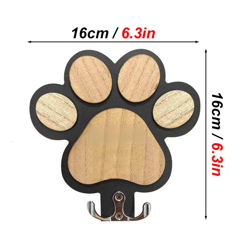 Closeup of black paw print wooden leash hook with dimensions, approximately 16cm wide and tall