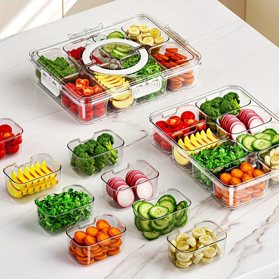 Clear divided snack containers showing removable individual compartments with fresh fruits and vegetables on a white countertop