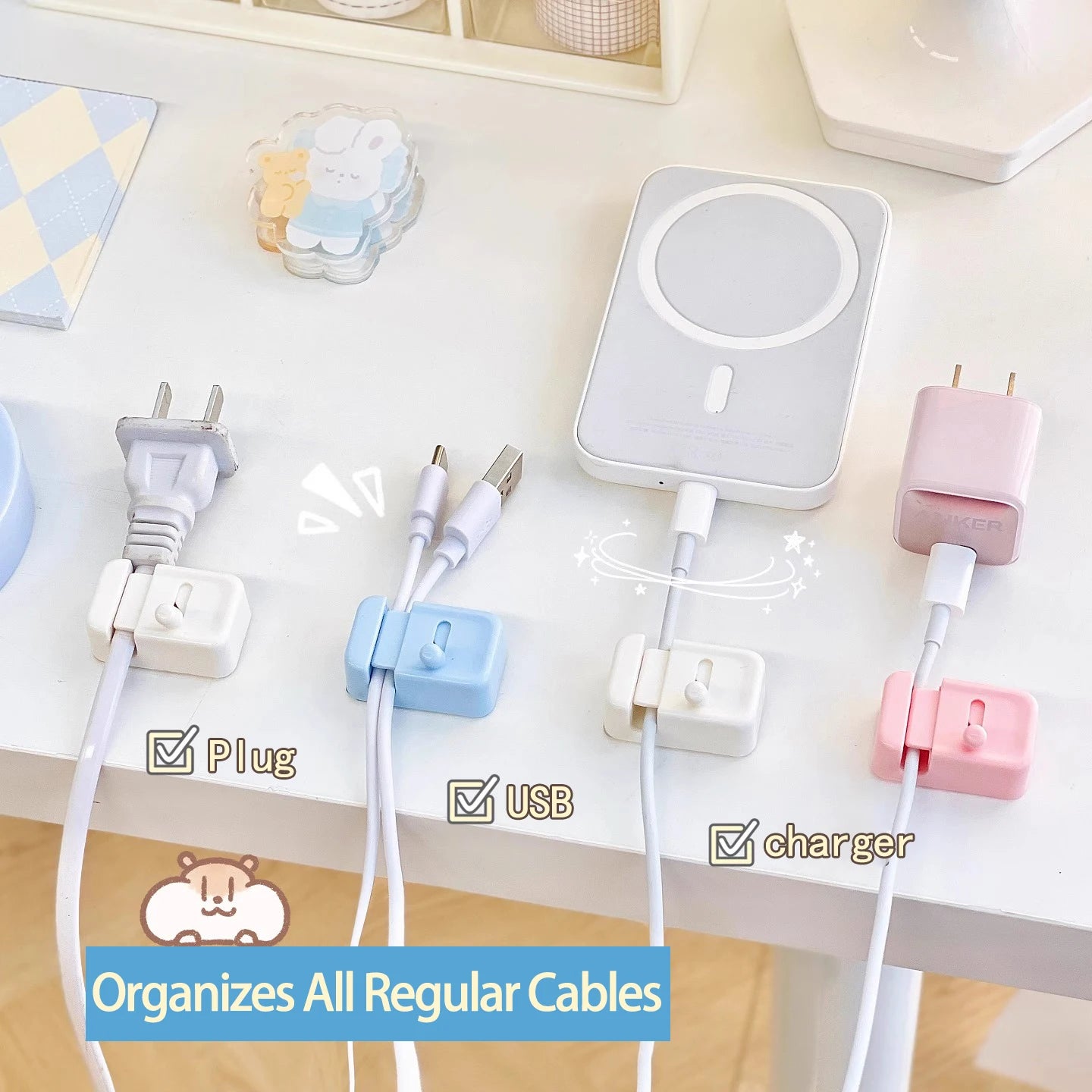 Multiple colors of cable clips attached to a desk, organizing different charger, USB, and plug cables