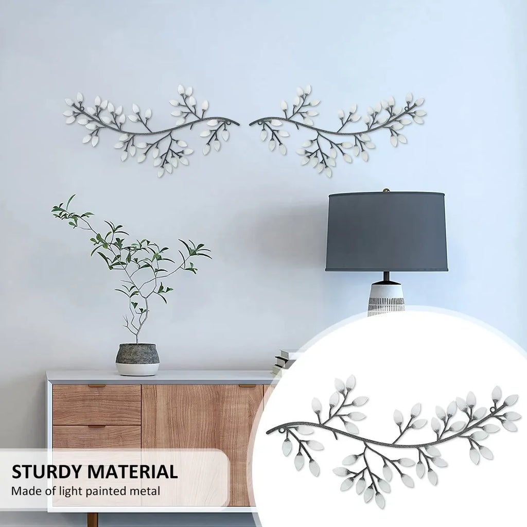White olive branch wall sculpture hung above a console table with lamp, highlighting light painted metal material