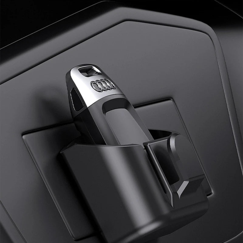Black rectangular key and card holder shown on a car dashboard surface