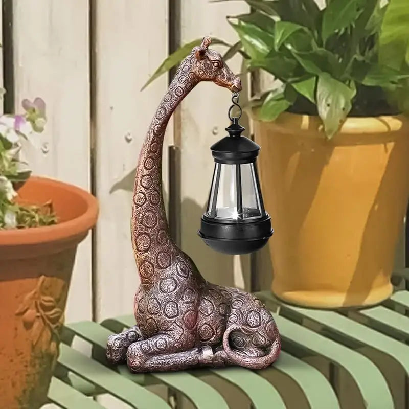 Giraffe resin animal lantern on a patio table among potted plants