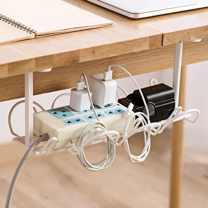 wire cable tray mounted on wood desk with power strip and chargers organized