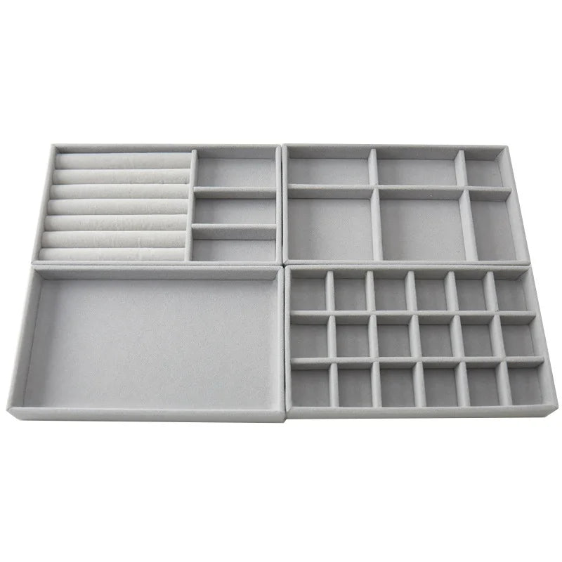 Set of empty grey velvet jewelry trays arranged together for visualizing multi-tray organization